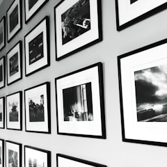 Gallery exhibition wall with framed black and white photographs