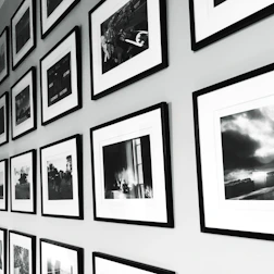 A sleek modern office wall decorated with minimalist photographic canvases.