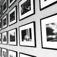 Gallery wall featuring elegant framed photos in a clean, bright room.
