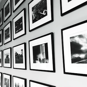 A sleek modern office wall decorated with minimalist photographic canvases.
