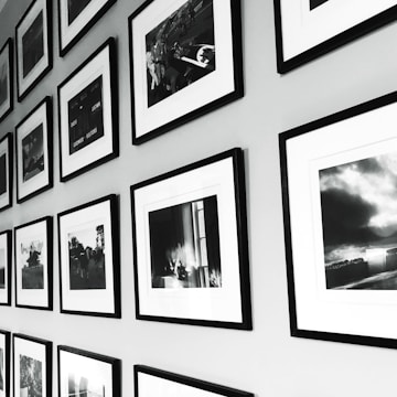 Gallery exhibition wall with framed black and white photographs