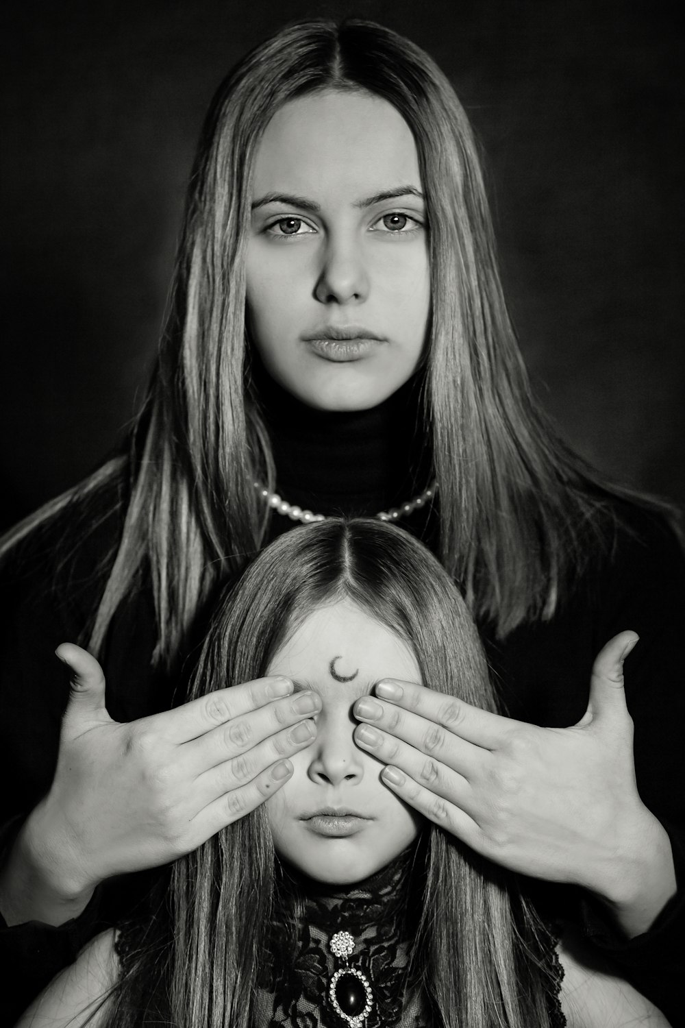 grayscale photo of woman and girl