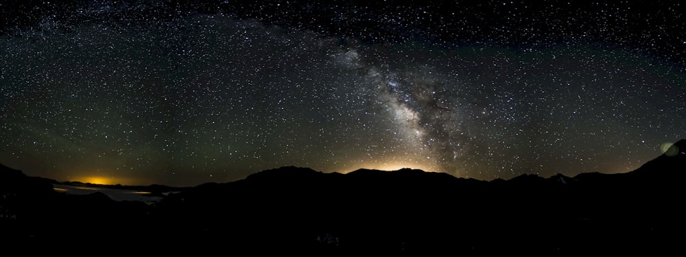 silhouette of mountainous terrain under milky way