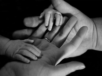 babys hand on human palm