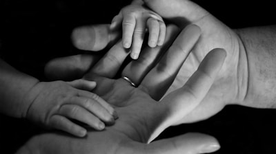 babys hand on human palm