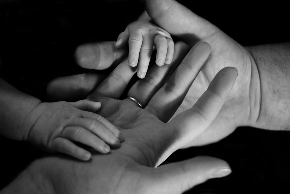 Mano de bebé en la palma humana