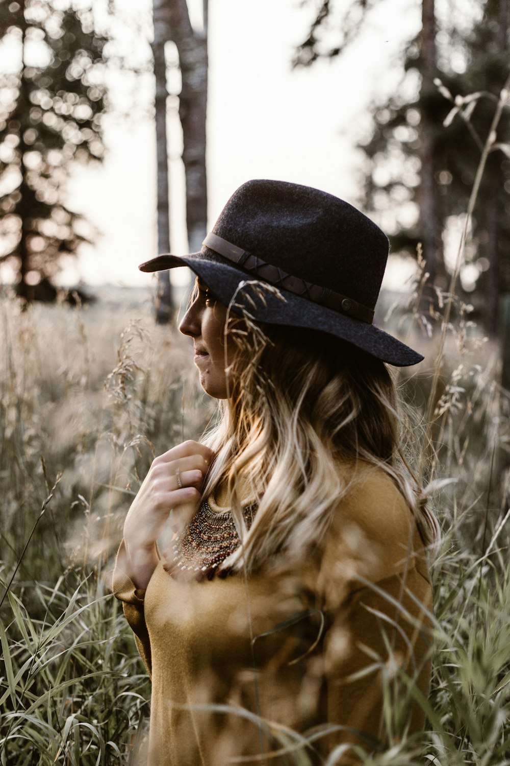 woman standing between ground covered with grass