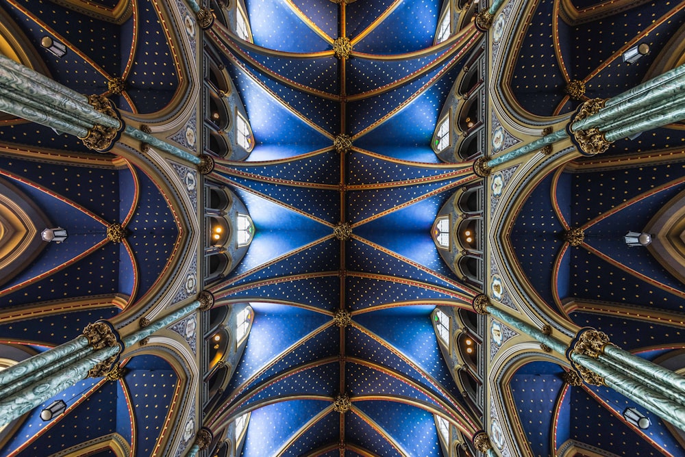 o teto de uma catedral com um design azul e dourado