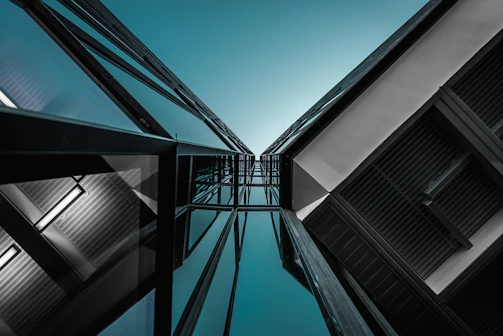 Dynamic shot of a modern architectural building from a high angle, showcasing sleek lines and shadows.