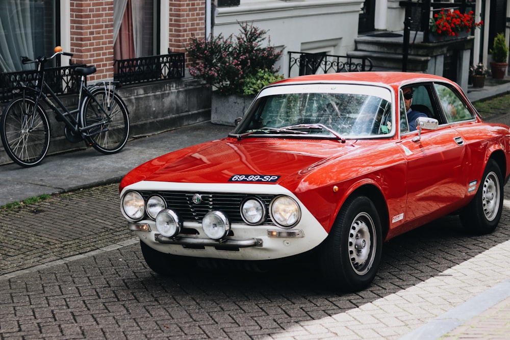 red and white sedan on road