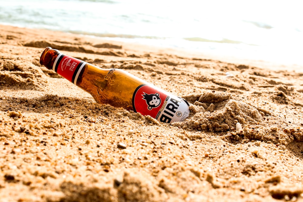 brown glass bottle over brown sands