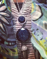 Casual chic outfit featuring a printed top and layered silver jewelry.