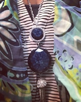 A stylish outfit featuring a bold necklace and matching accessories in an urban setting.