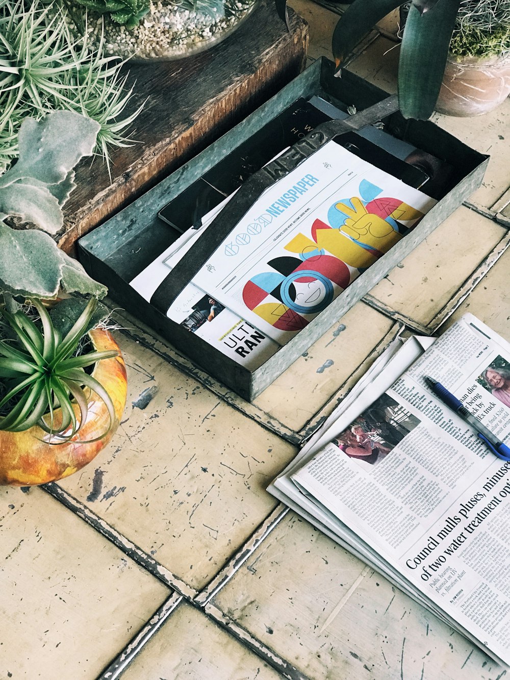 white newspaper article on beige floor tiles