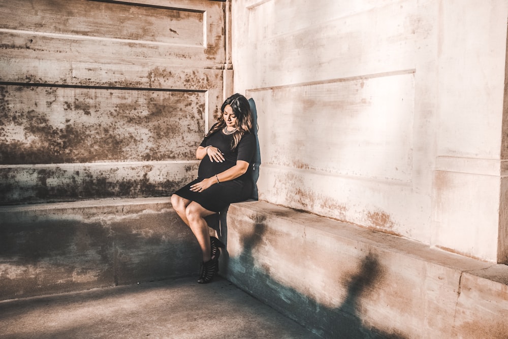 woman sitting on concrete pavemen