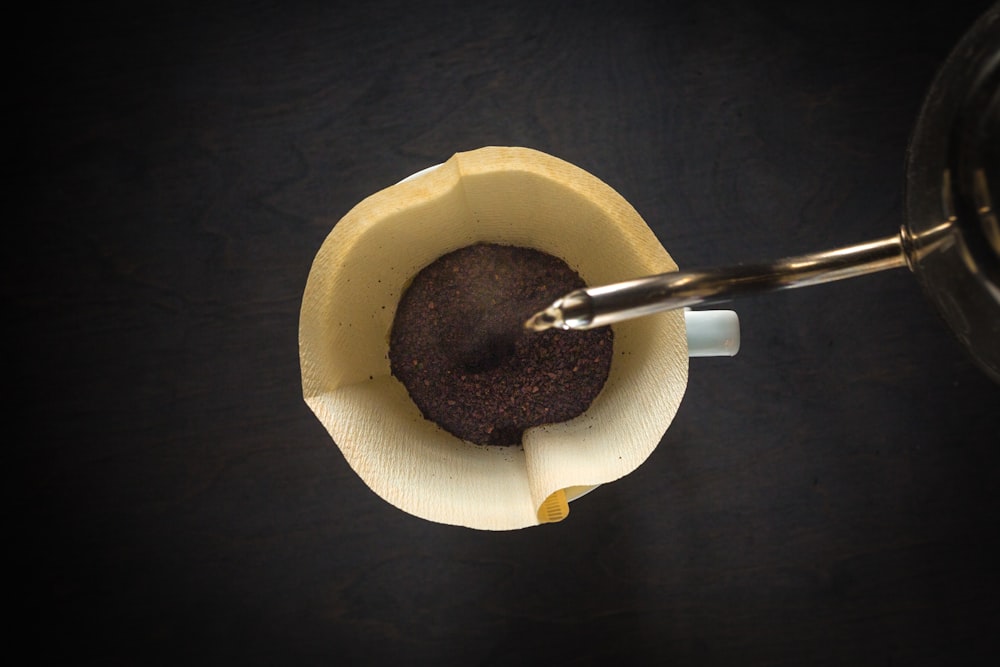 water pouring on brown mug