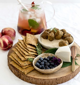 assorted-cook foods on round brown wooden tray