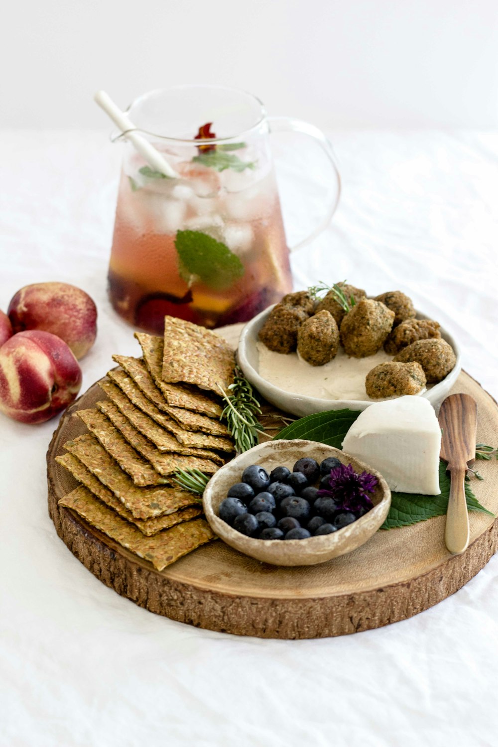 assorted-cook foods on round brown wooden tray