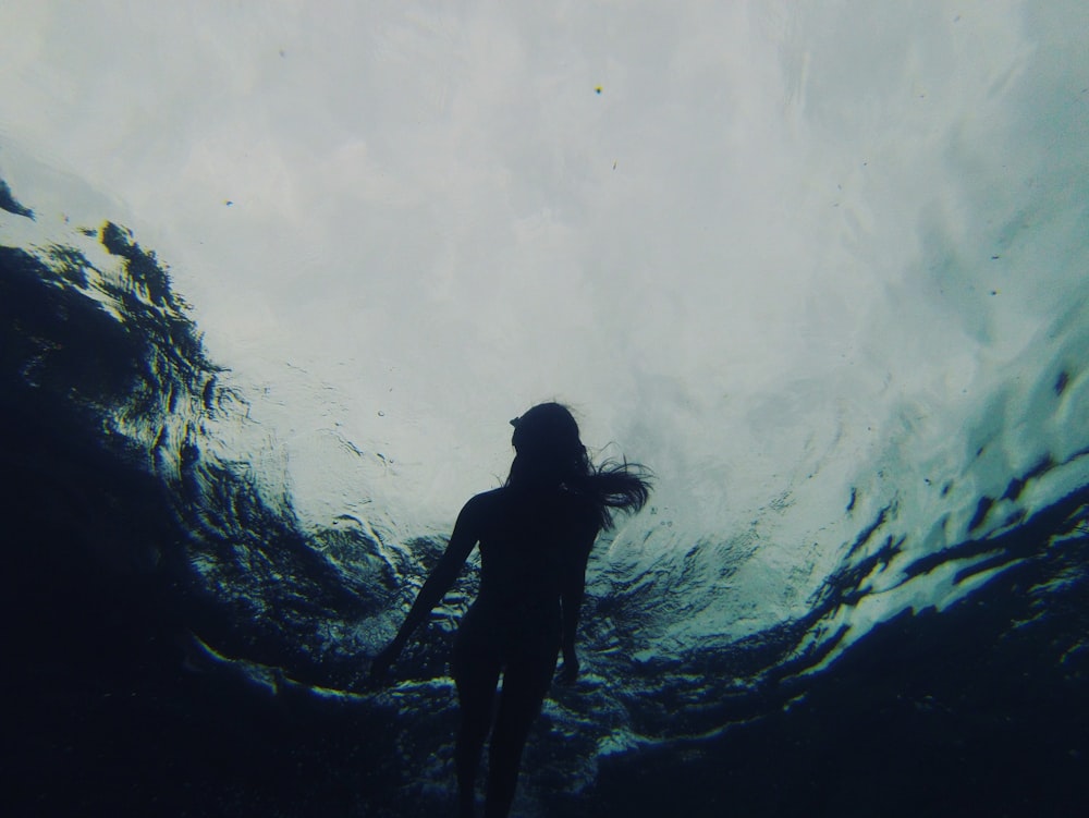 woman swimming in body of water