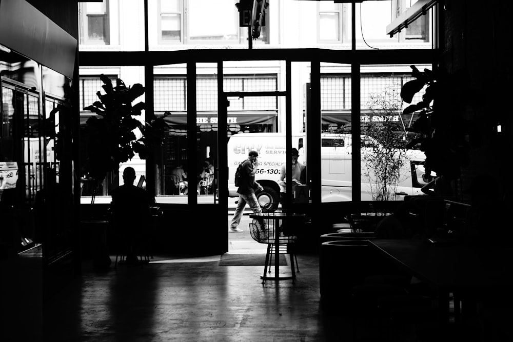 grayscale photo of house and people