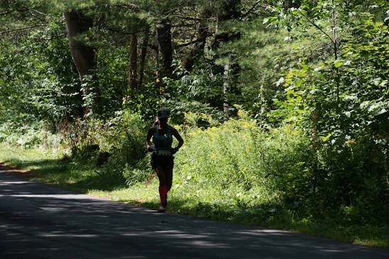 A runner sprinting along a colorful trail at sunrise, vibrant hues lighting the path ahead.
