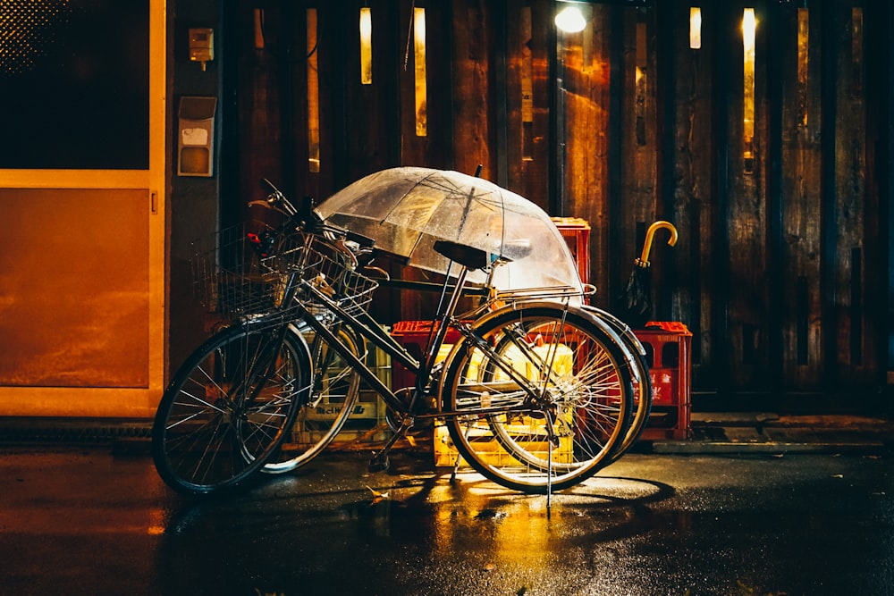 clear umbrella on black bicycles