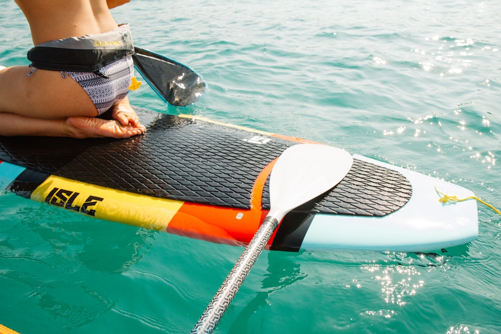 man riding paddle board