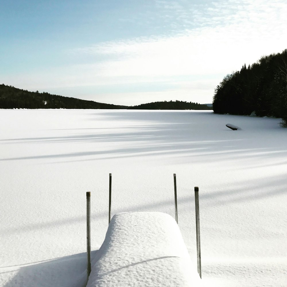 photo of snow coated dock near mountain