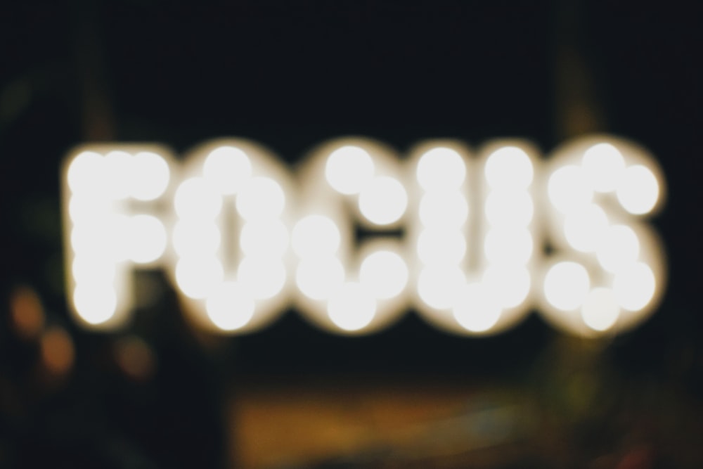 A blurred image of lights that say "FOCUS."