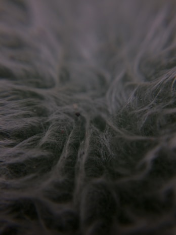A close-up of a fiberglass material sample with a smooth texture.