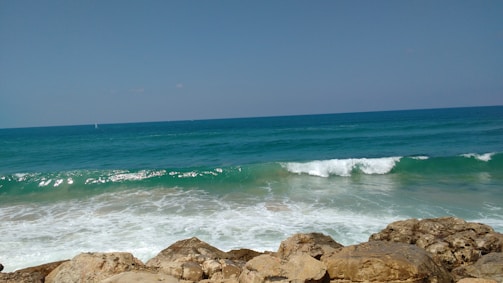 A serene ocean scene with waves crashing against rocks.