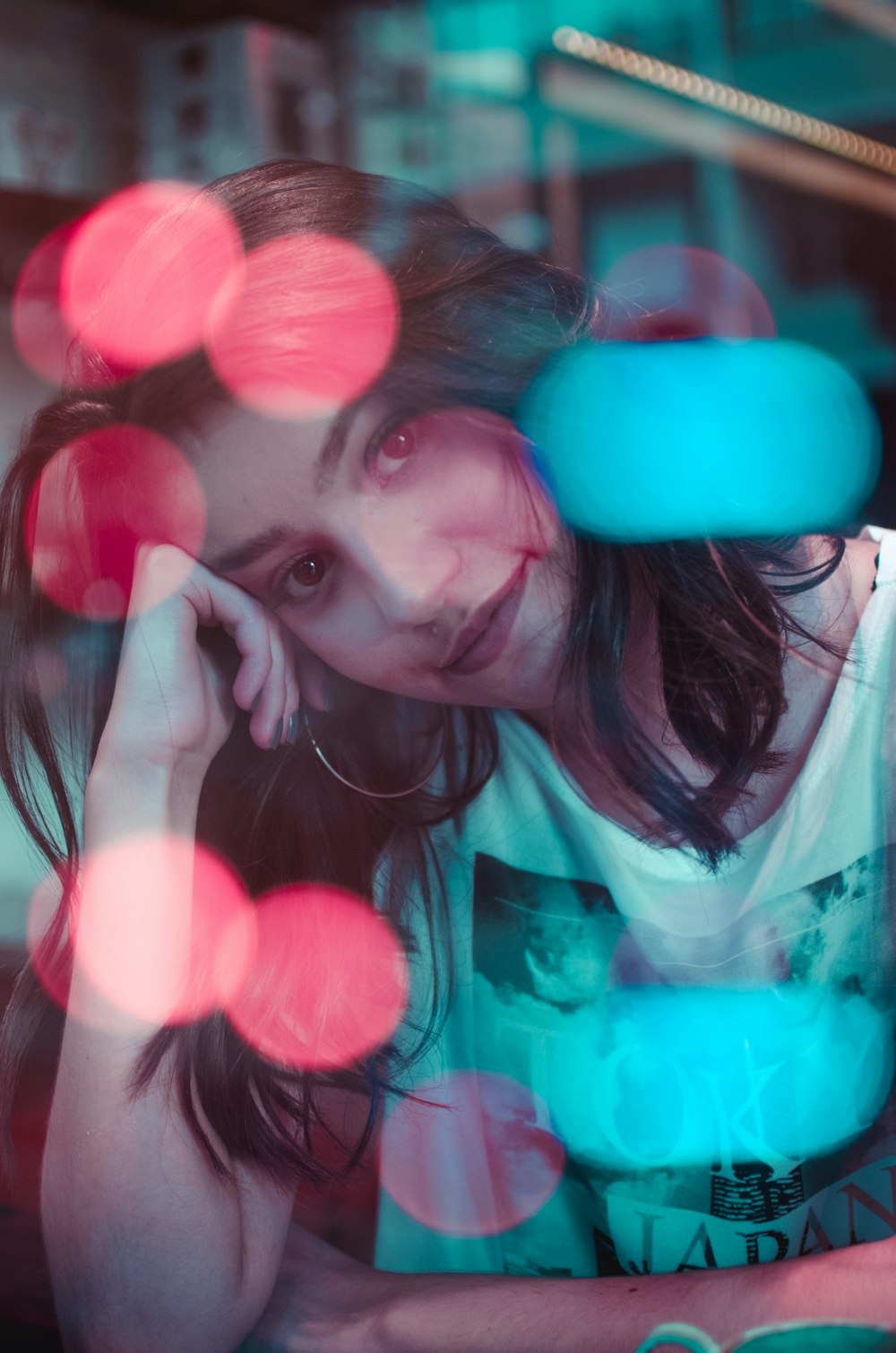 photo of woman wearing white top with bokeh lights