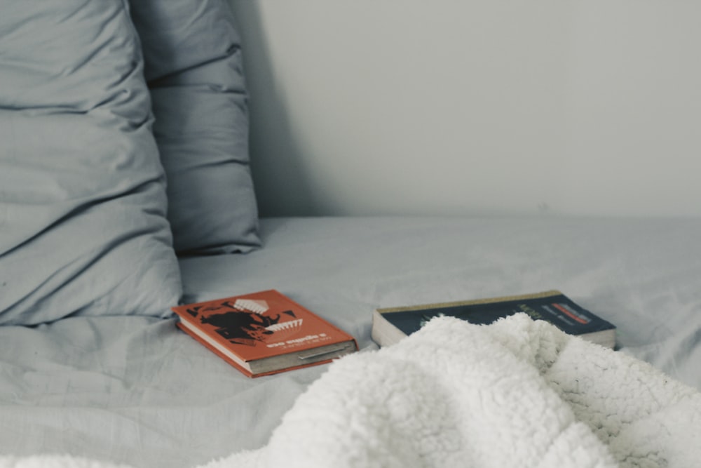 two novel books on bed