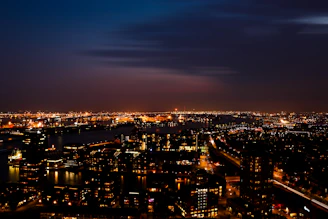 Evening skyline of Philadelphia with glowing city lights reflecting over the Schuylkill River.