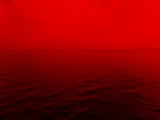 photo of ocean with red lights