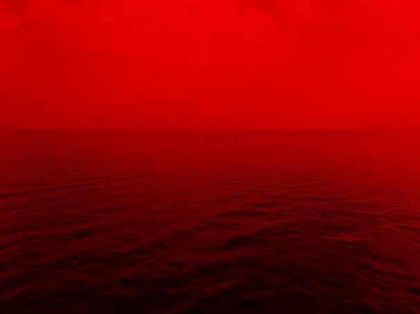 photo of ocean with red lights