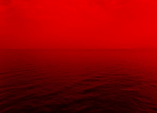 photo of ocean with red lights