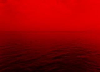 photo of ocean with red lights