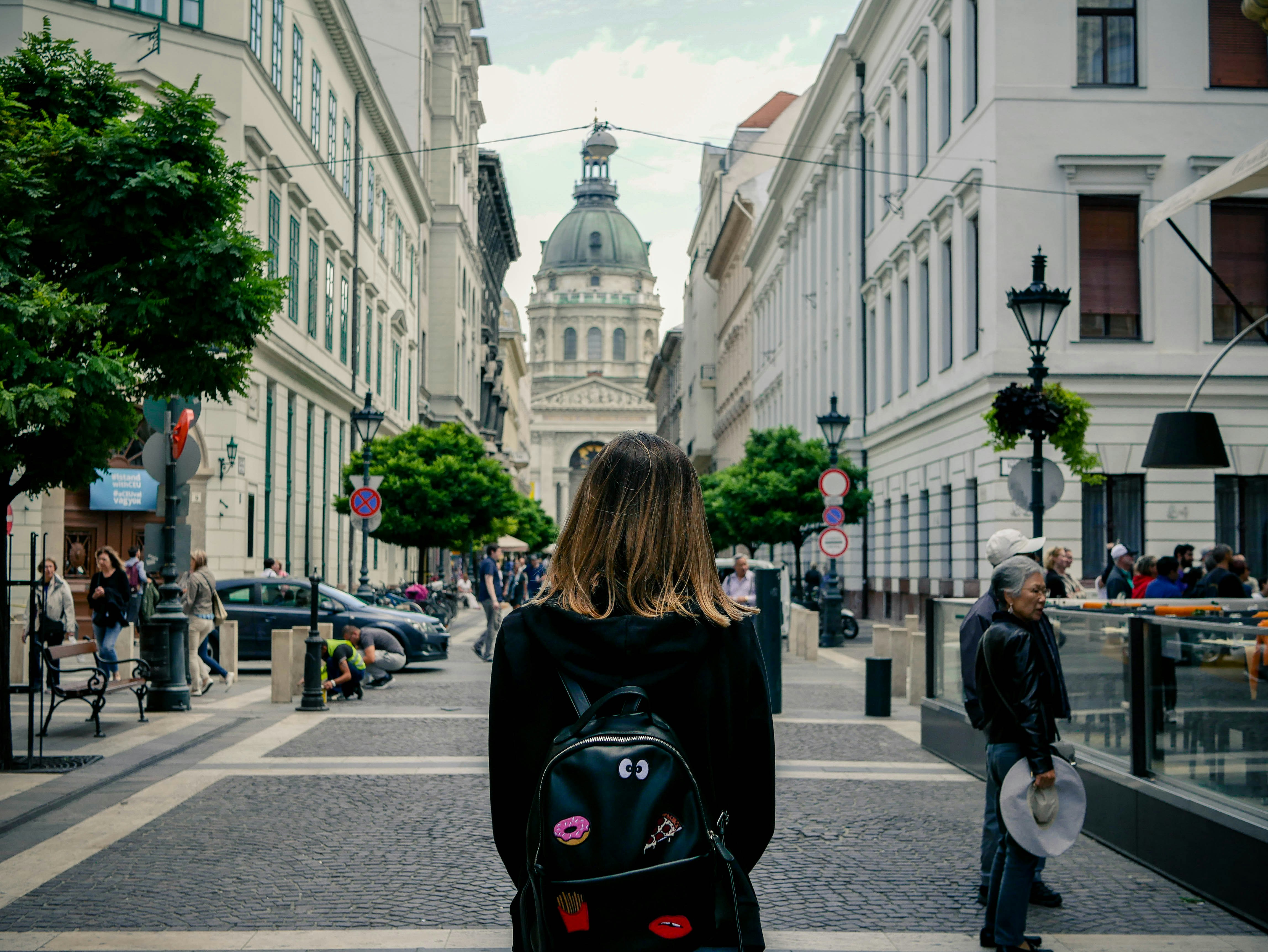 woman carrying backpack hungary teams background