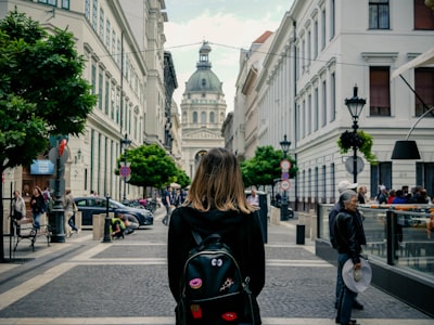woman carrying backpack hungary teams background