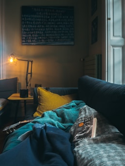 book on gray and white blanket