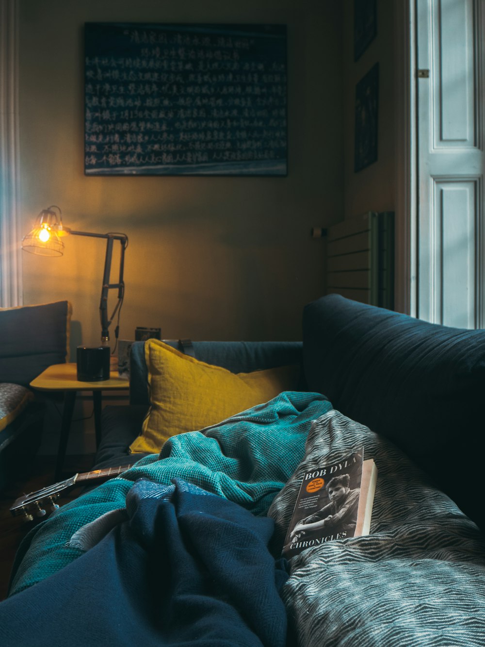 book on gray and white blanket