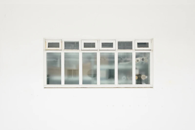 Minimalist casement window against light wall