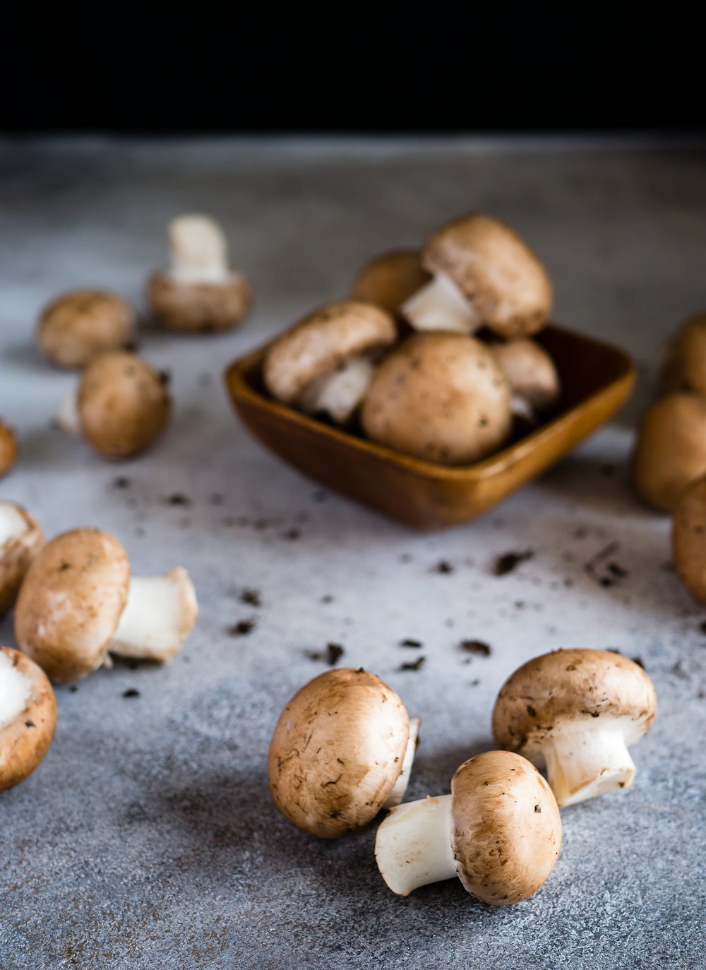 brown mushrooms on gray surface