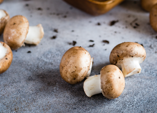 brown mushrooms on gray surface