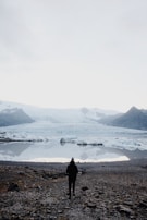 person walking towards sea