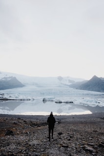 person walking towards sea