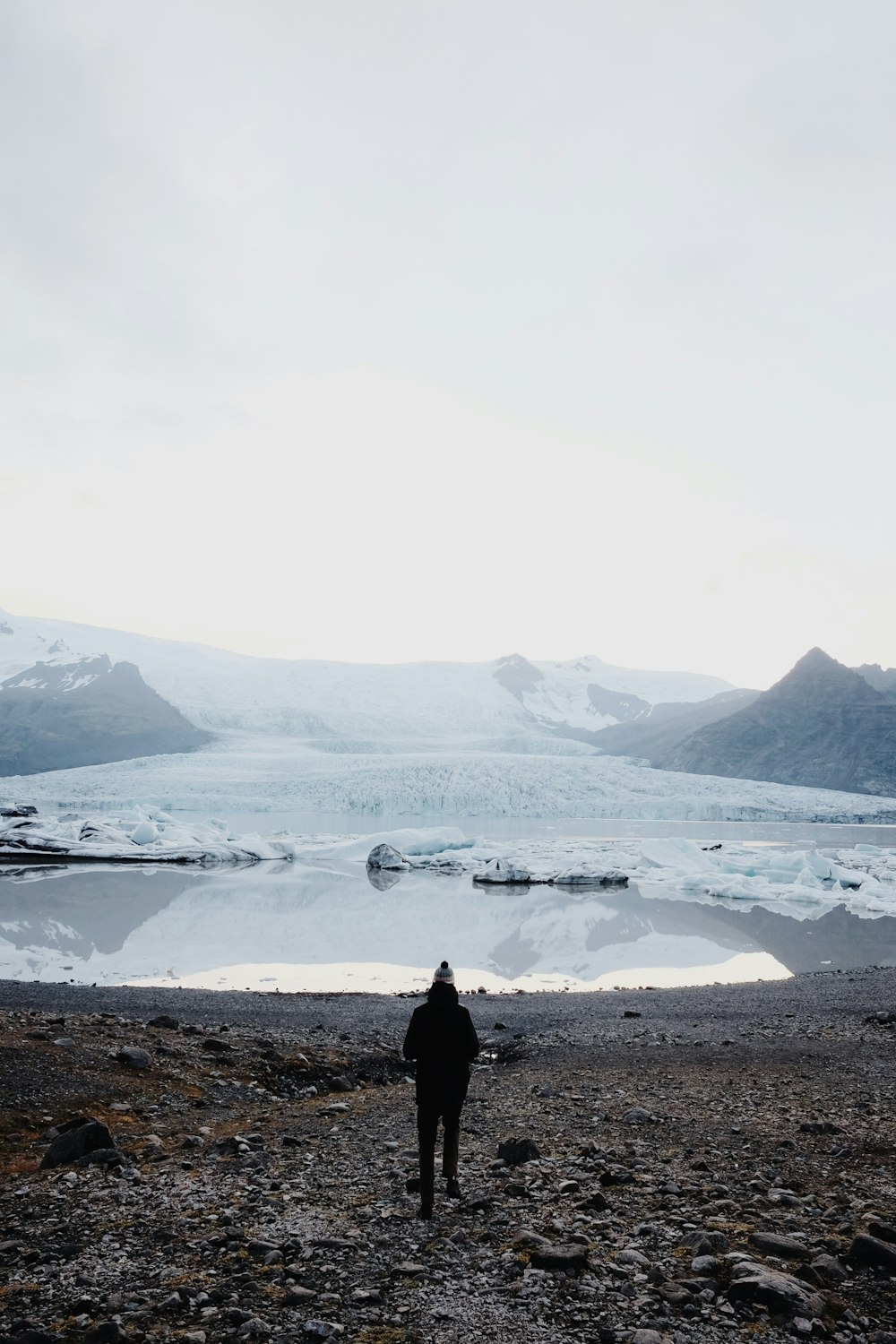 person walking towards sea