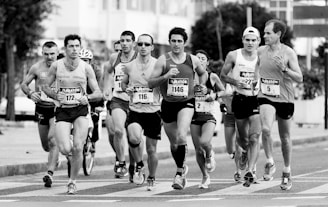 grayscale photo of people performing marathon
