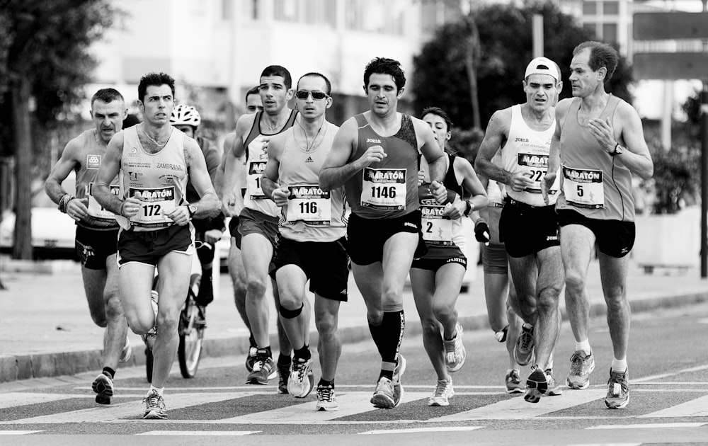 grayscale photo of people performing marathon